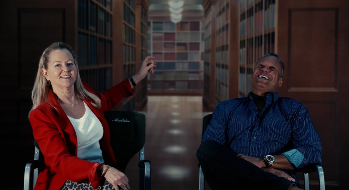 Two documentary interview subjects seated in a screening room